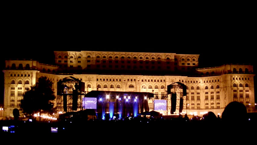 Cheering crowd at rock concert in front of the palace of the parliament in