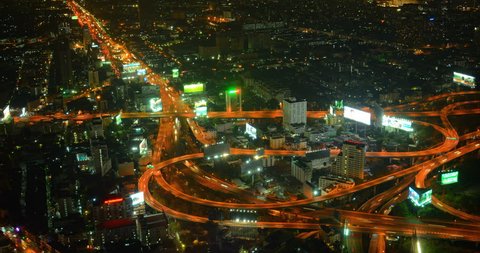 BANGKOK. THAILAND - CIRCA FEB 2015: Dramatic. Abstract Clip of Heavy Night Time Traffic on a Complex. Looping Highway Interchange in Bangkok.
