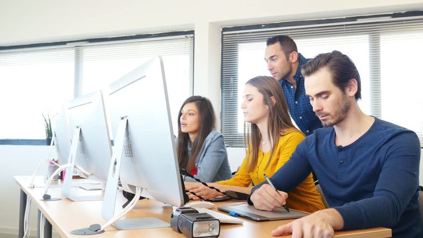 Group of five young people student with their teacher in photography school learning photo editing with desktop computer, camera and photo equipment | Shutterstock HD Video #25387988