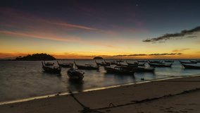 4K Day to Night timelapse zoom in motion video of fishing boat on the Lipe beach at twilight, Satun, Thailand.
