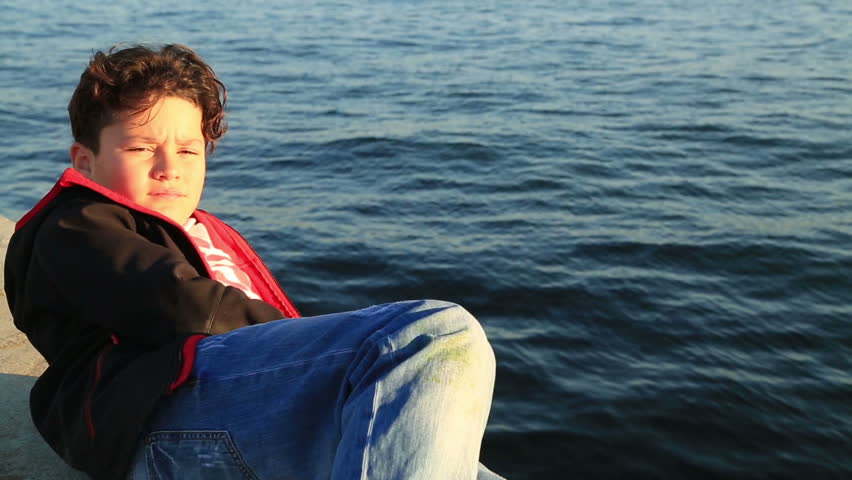 Portrait of young happy teen boy looking at camera and smiling at the outdoors