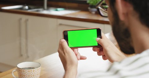 Close up Man holding smartphone green screen chroma-key green screen sharing authentic social media