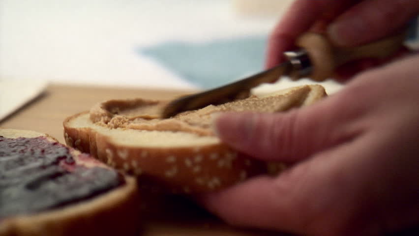 Woman making peanut butter and jelly sandwich