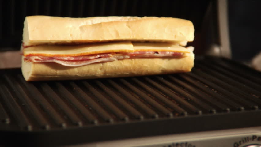 placing panini sandwiches on grill