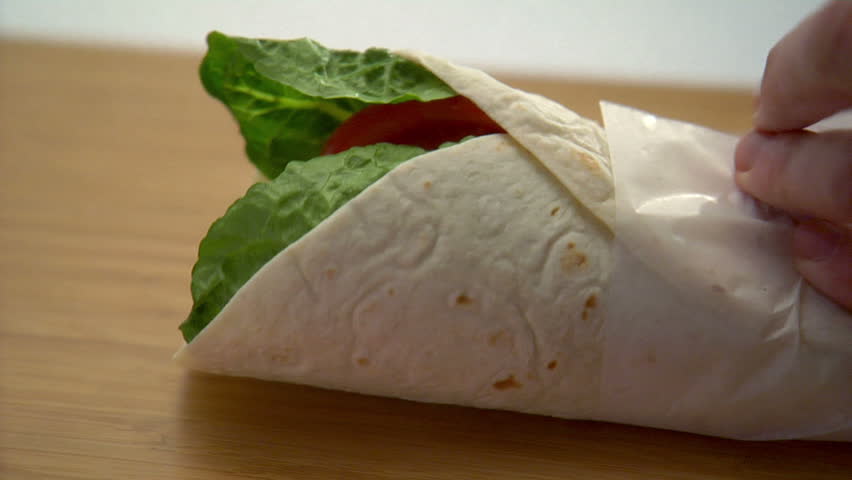 close-up preparation of chicken wrap sandwich