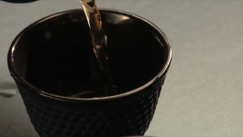 Pouring tea into asian style cups