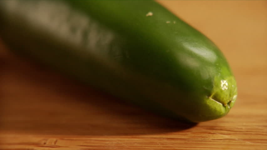 Chef slices green jalapeno