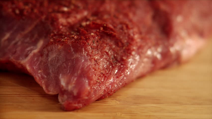 pan over chef slicing seasoned flat-iron steak