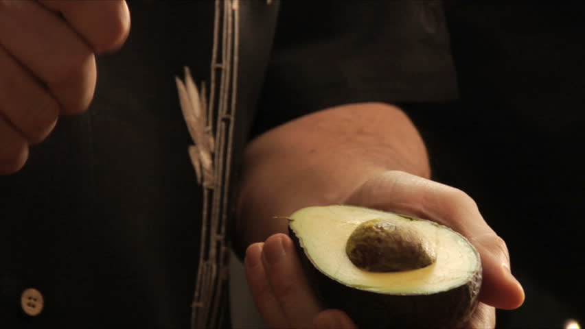 mexican chef cuts and pits avocado for guacamole