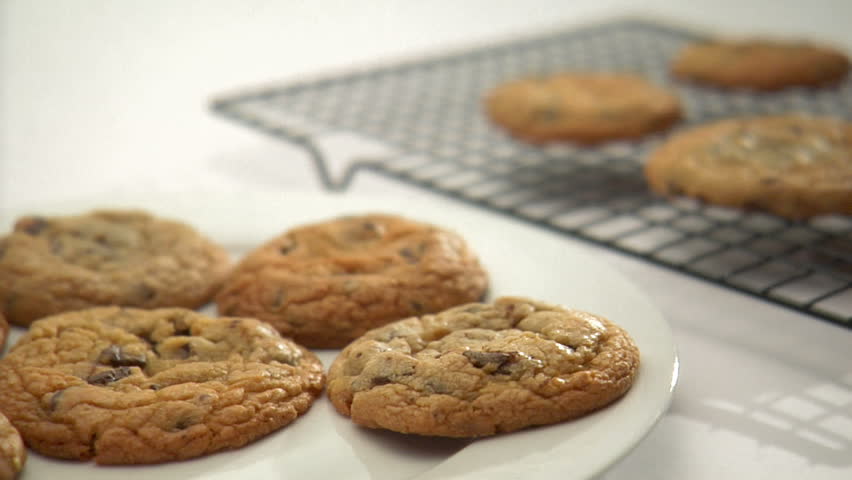 lock-down of person moving cookies from cooling rack to plate