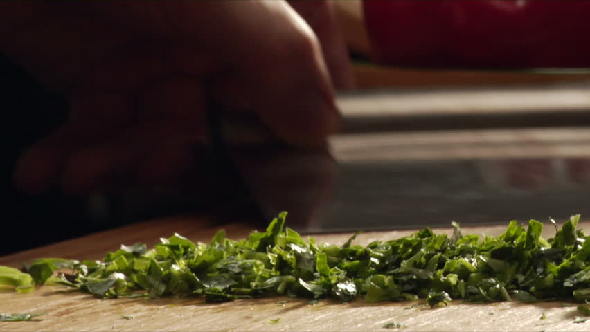 A chef chops parsley