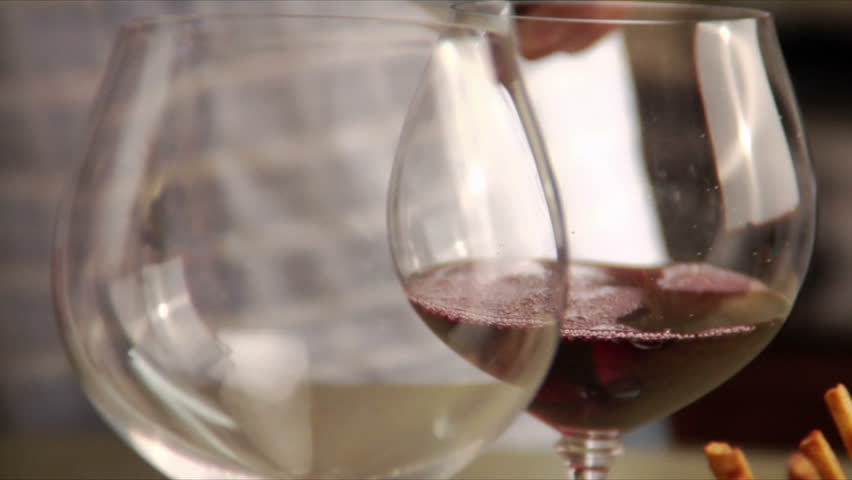 close-up of man pouring red wine