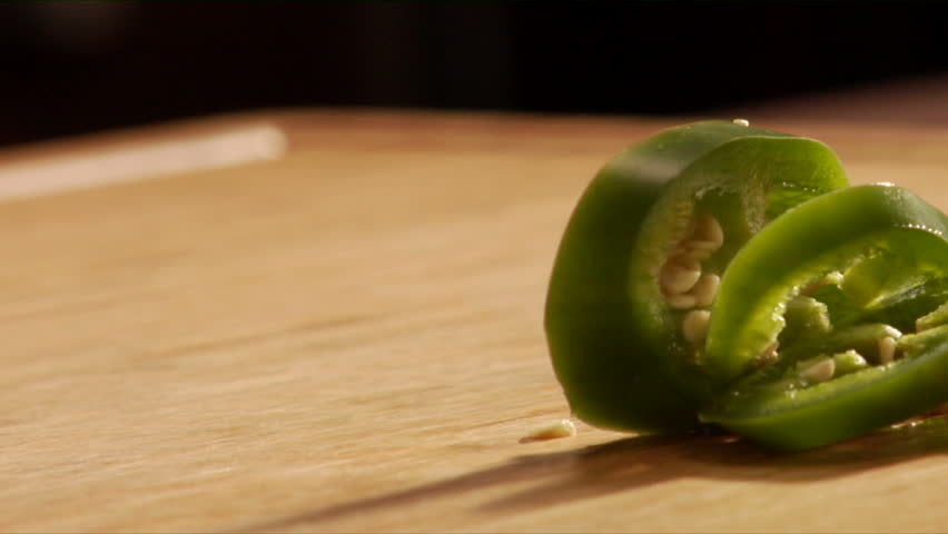 Chef slices green jalapeno