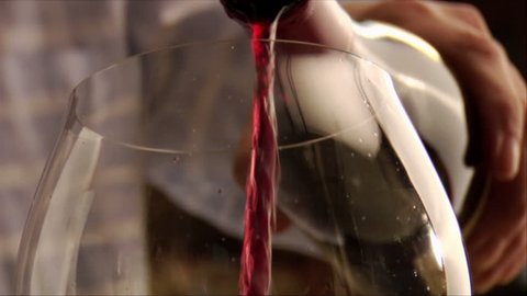 close-up of wine being poured