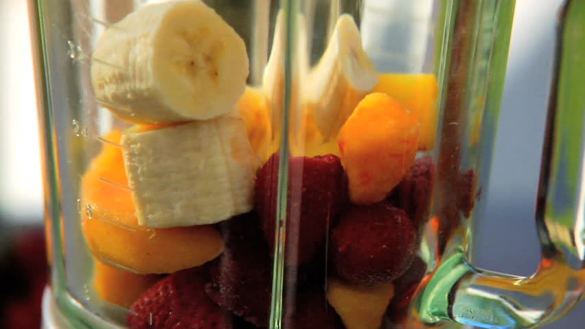 Fruit being added to blender for smoothie