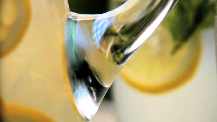 Close-up of glasses of lemonade and lemonade in pitcher