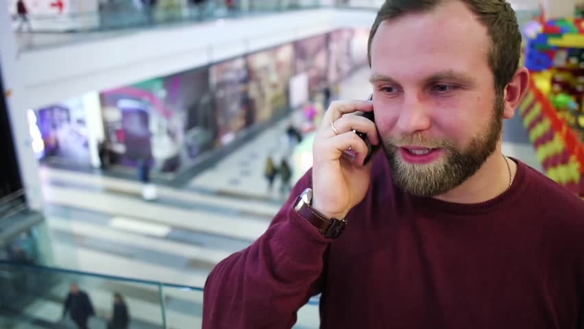 Nice man talking on the phone in shopping Mall