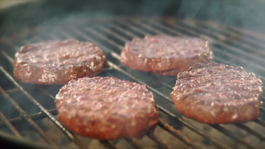 Flipping hamburgers on the grill