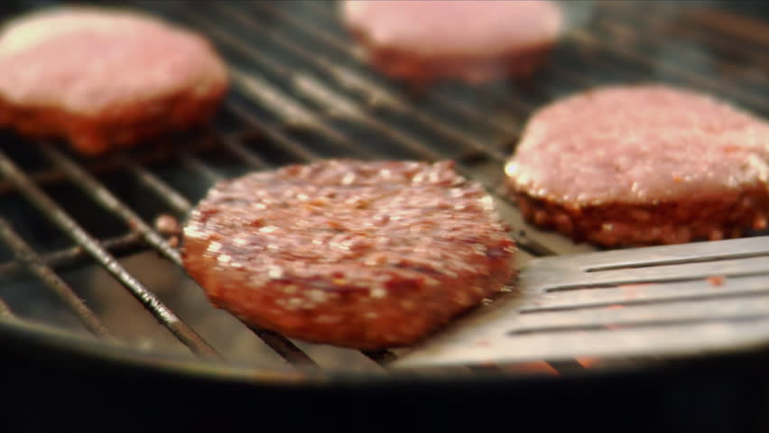Flipping hamburgers on the grill