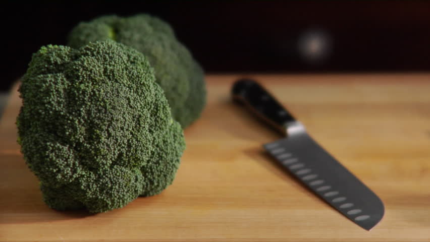 Close-up of chef chopping broccoli.