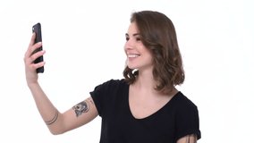 Happy modern teenager girl using wrist smart watch and smart phone isolated