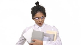 Joyful female student holding stack of books isolated on white background
