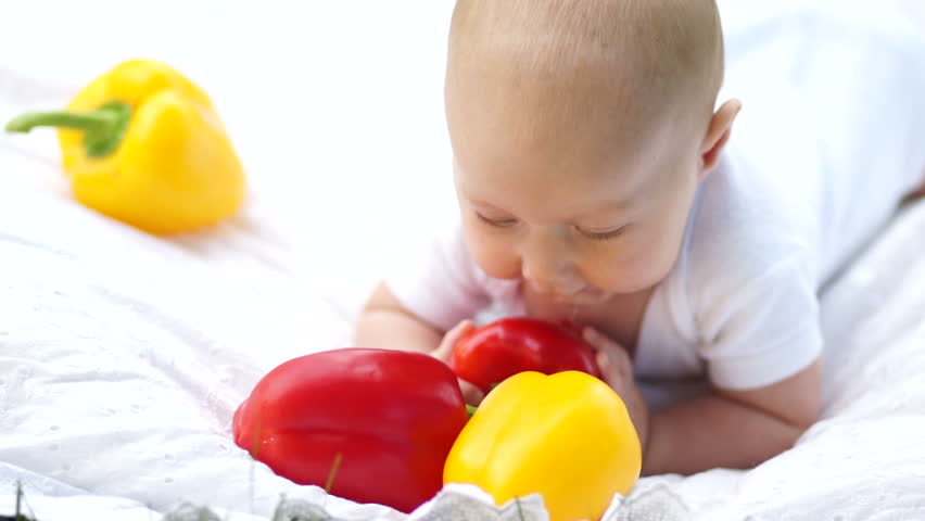 Baby trying to taste vegetables
