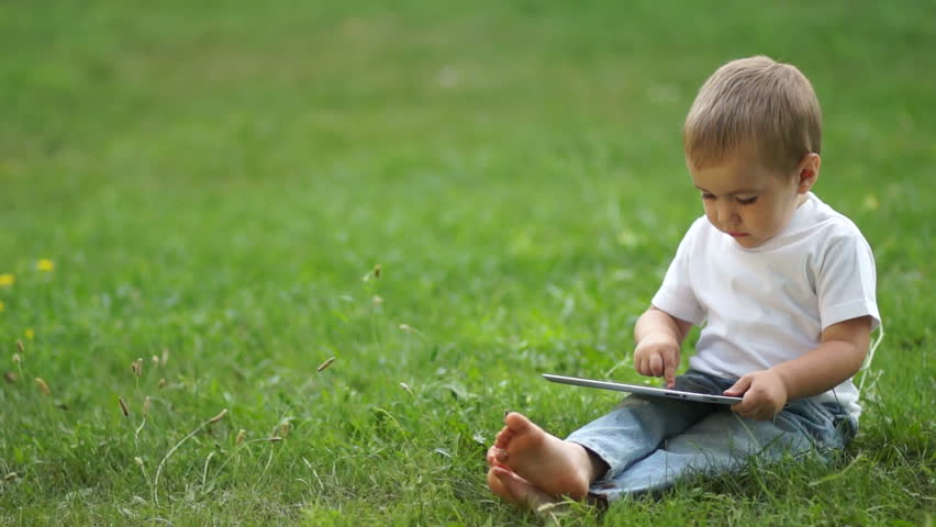 Boy with the Tablet PC outdoors
