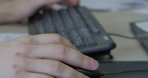 Close-up of typing on laptop keyboard male hands. Man work on Mouse and keyboard. in office.