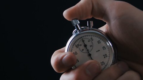 One person starting up a stopwatch at black background