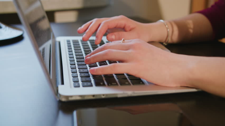 Dolly shoot female hands typing text on laptop keyboard | Shutterstock HD Video #25432415
