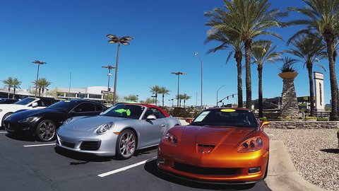SCOTTSDALE AZ/USA: February 28, 2017- Rolling by used expensive sports cars at a dealership in Scottsdale, Arizona. Clip reveals a row of pricey import vehicles on display in pre-owned car lot.
