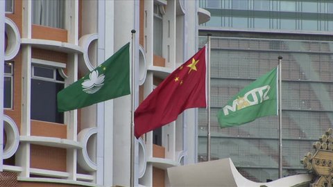 Macau, China - CIRCA March, 2007: Three flags flap in the wind, the Chinese national flag with Macau flag