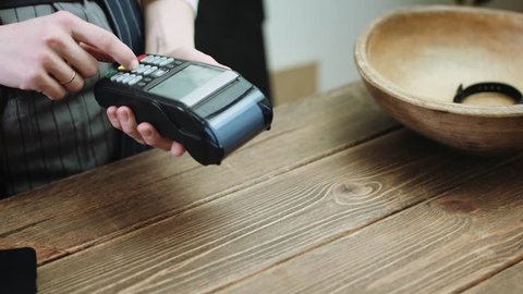 Cropped view of customer paying with credit card