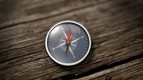 Compass with a needle pointing North on a wooden table. Close up view. Objective concept. 3D Rendering