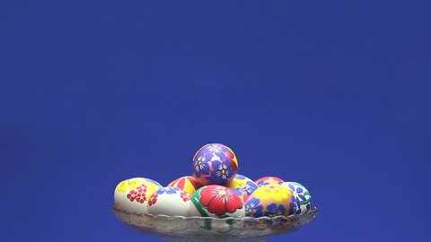 Crystal vase with Easter eggs revolves and above it appears the text "Happy Easter"