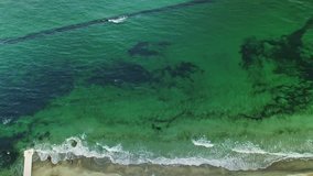 Aerial upside down view of green colored sea and coastline