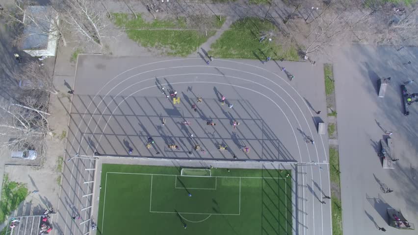 Aerial topside down view of football field with amateur football players Royalty-Free Stock Footage #25466732