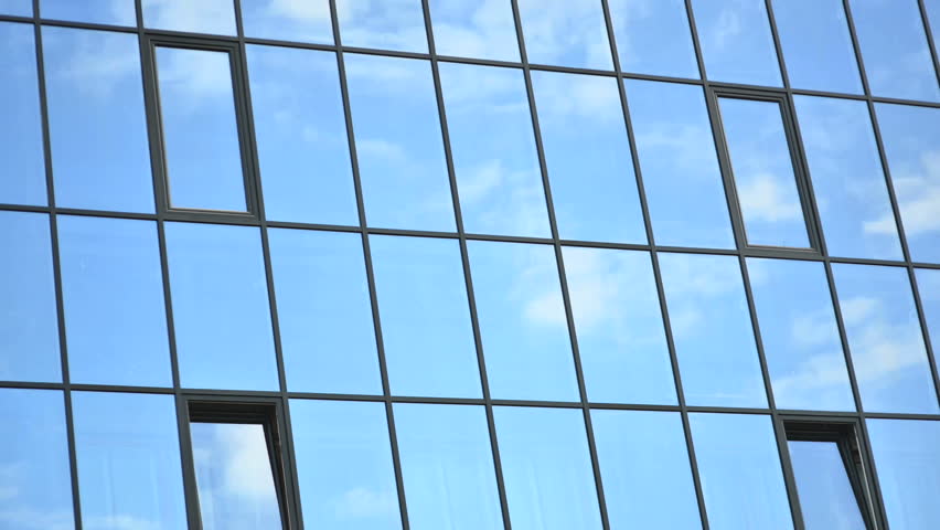 Time lapse of clouds, reflected in the windows of building | Shutterstock HD Video #2547671