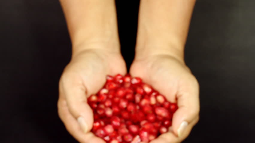 Woman hands holding Pomegranate seeds