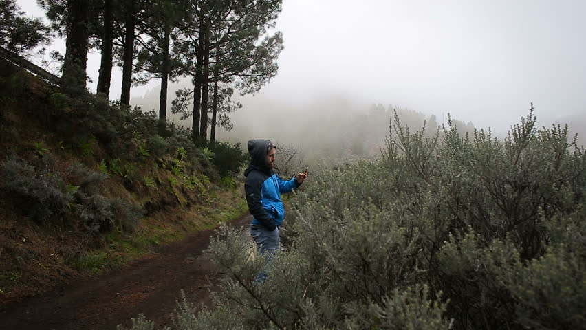 Tourist making photo of mountain landscape