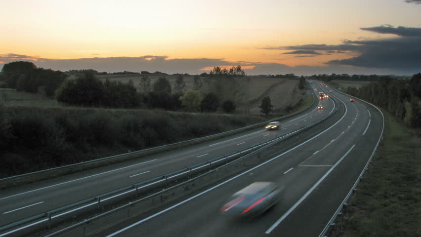 HD Time lapse of sunset over highway.