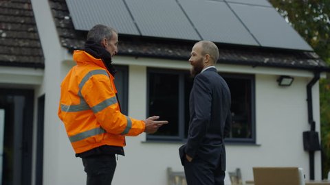 4K Engineer & homeowner discuss solar panels on roof & shake hands on a deal