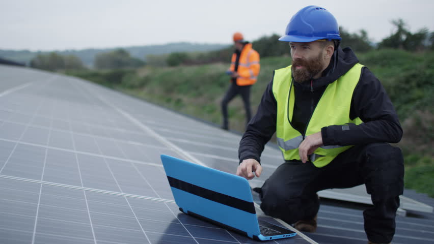 4K Technician with laptop checking the panels at solar energy installation Royalty-Free Stock Footage #25490174