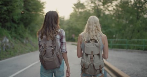 Best friends hiking together Two young woman sharing travel adventure Girls enjoying nature on summer vacation