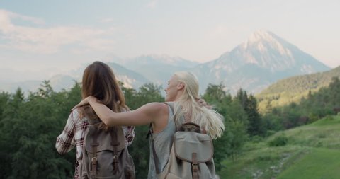 Two girl friends taking selfie photo Woman hiking in Italian Alps photographing self portrait with mountain background exploring wild outdoors together
