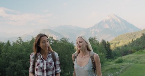Two girl friends taking selfie photo Woman hiking in Italian Alps photographing self portrait with mountain background exploring wild outdoors together