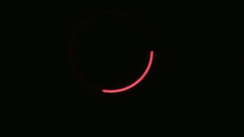 Light painting.Single laser light spinning fast creating red color colour ring on black background