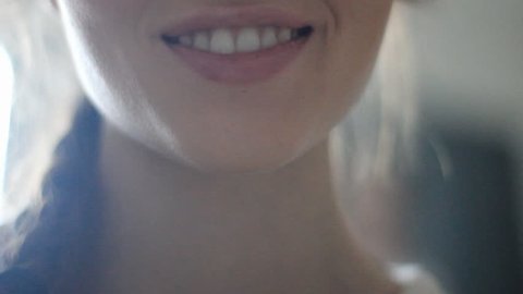 Big close up of young woman's face smiling