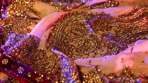Indian Wedding Preparation. Luxury Oriental Fashion Accessories: Female foot and Hands, Beautiful National Indian Bridal Golden Jewellery. Eastern Traditional Sari clothes. Color lenses, Candlelight.